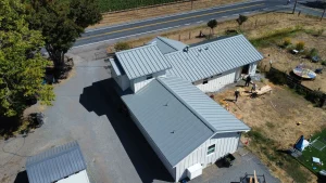 Drone view of a residential home with a new metal roof replacement in Santa Rosa