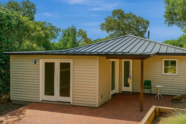 Single-story Sonoma County home with a newly installed standing seam metal roof surrounded by mature trees